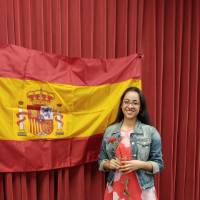 Estefania Montoya posing in front of Spanish flag